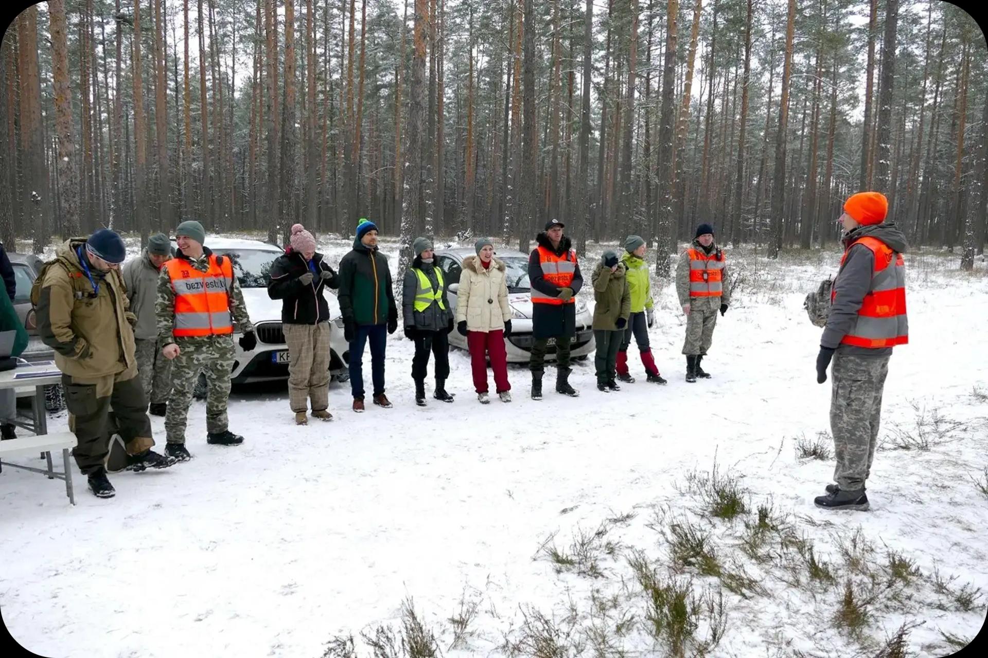 Image showing people in the woods going through SAR training and testing the ToTheRescue platform
