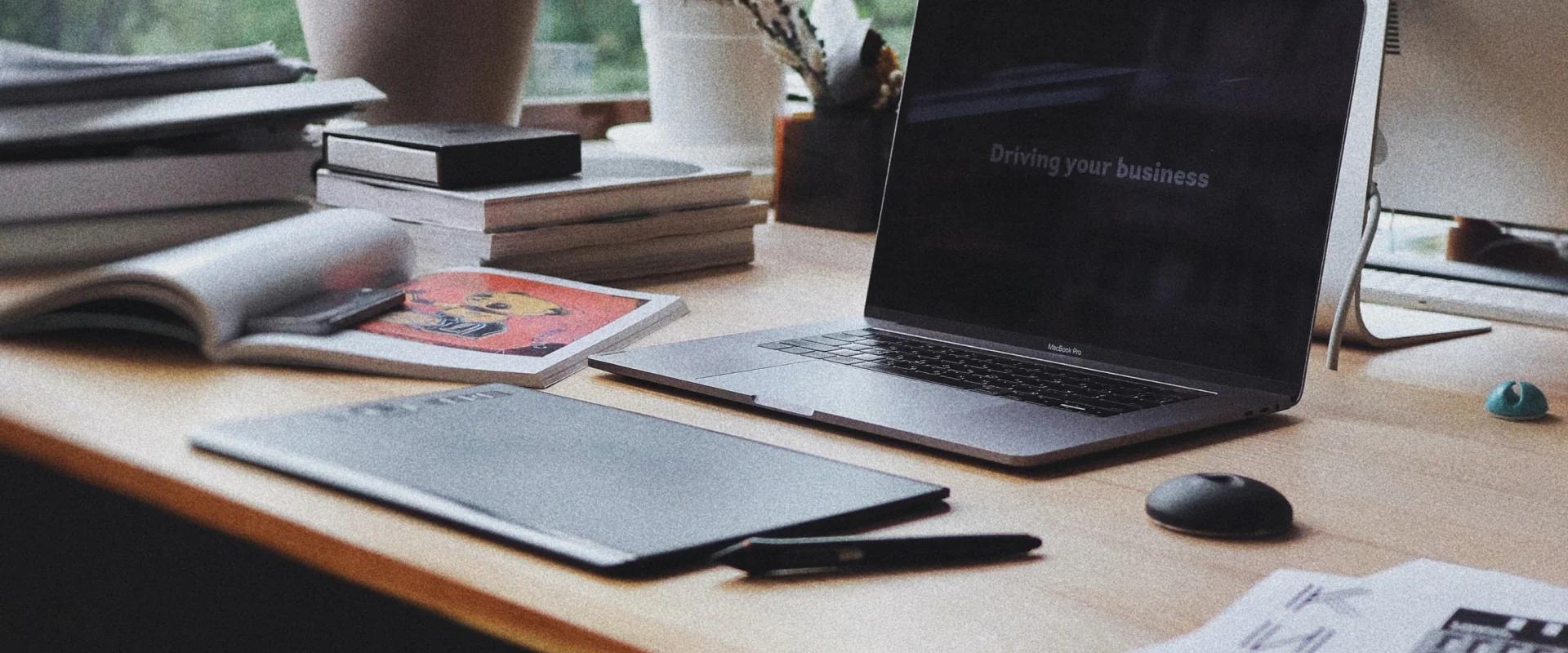 Work environment, on the table, laptop, books, potted flowers