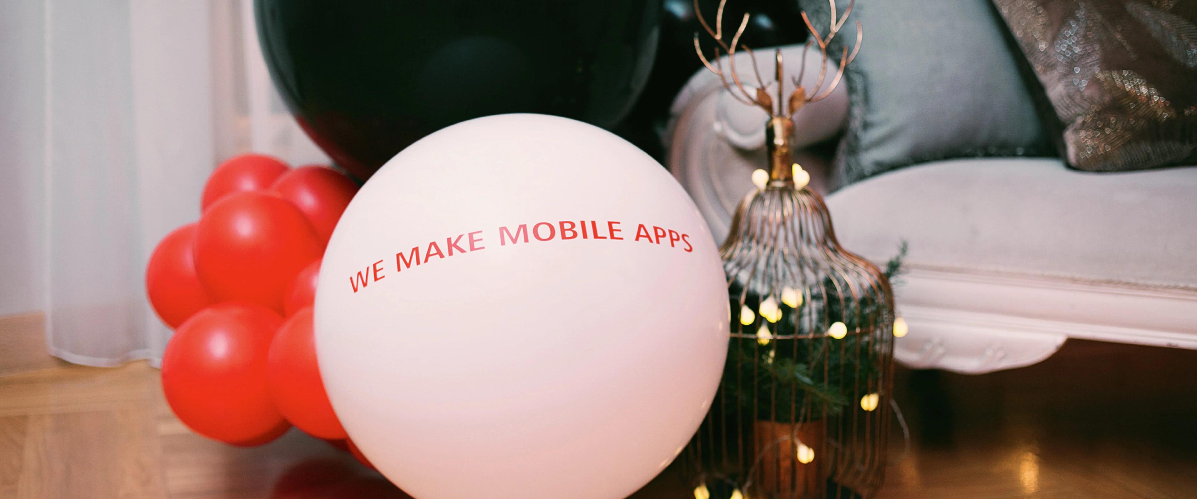 Close up view of interior and white balloon with text, we make mobile apps
