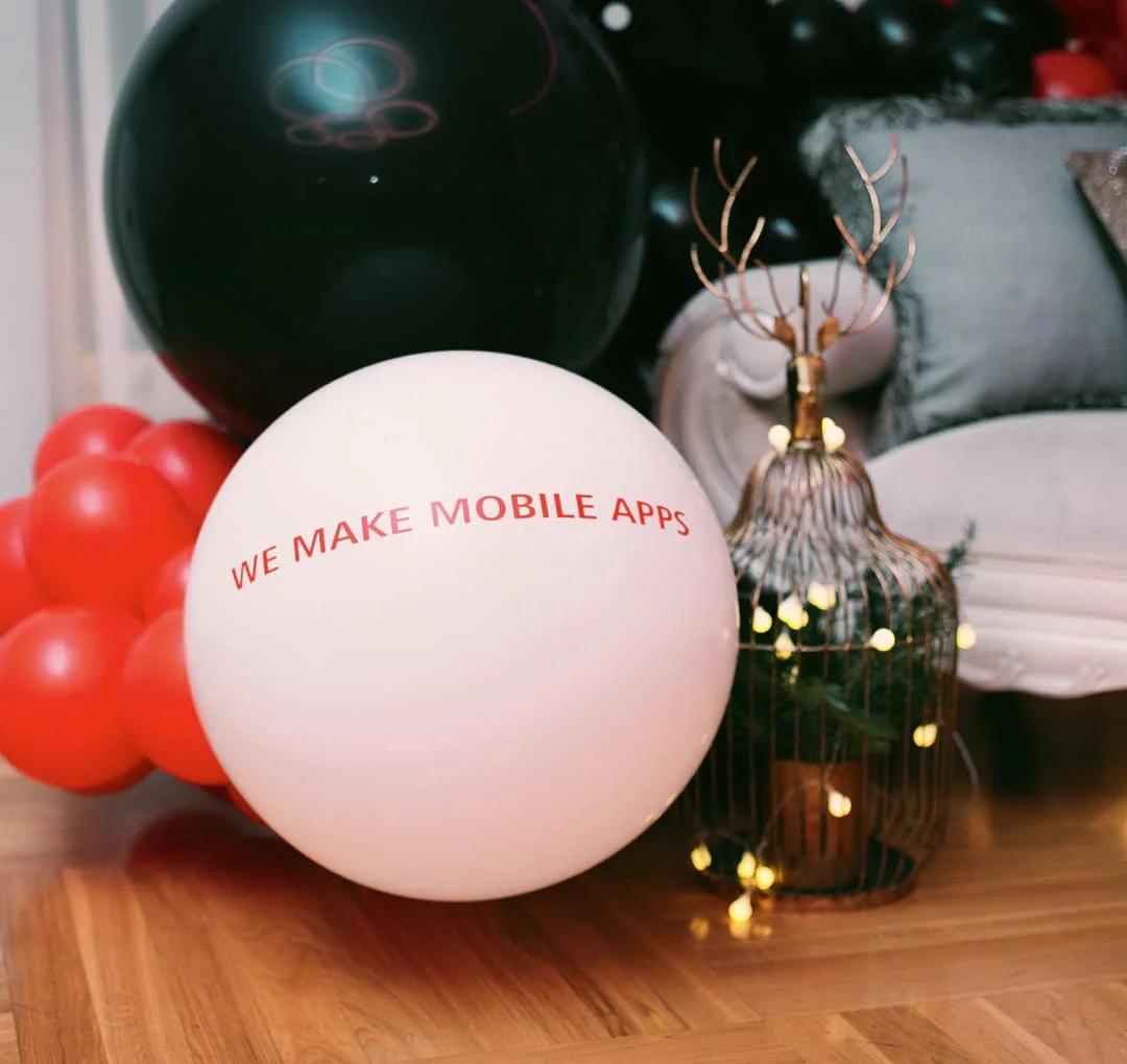 Close up view of interior and white balloon with text, we make mobile apps