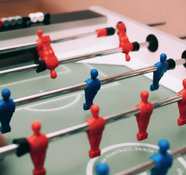 Close-up of table football with red and blue pieces