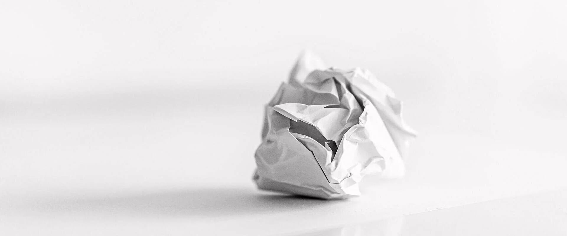Crumpled paper on white table